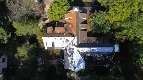 Aerial view of house surrounded by trees