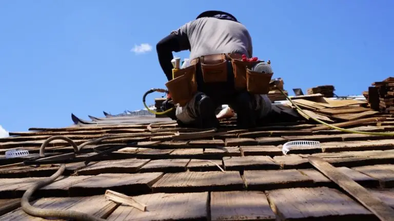 A TopLine Roofing employee installing cedar shake roof.