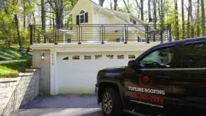 Topline Roofing truck parked at a completed roofing project.