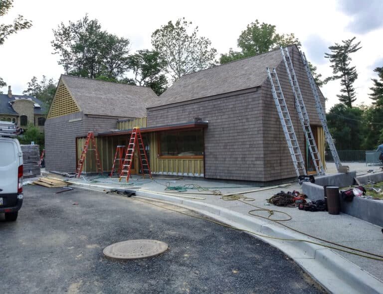 Residential construction site with ladders and equipment.